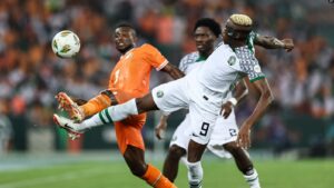 Nigeria's forward #9 Victor Osimhen (R) fights for the ball with Ivory Coast's defender #3 Ghislain Konan (L) during the Africa Cup of Nations group A football match against Ivory Coast at the Alassane Ouattara Olympic Stadium in Ebimpe, Abidjan, on January 18, 2024.